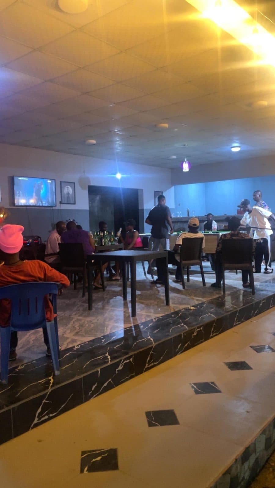 Friends at tables in the lounge with drinks
