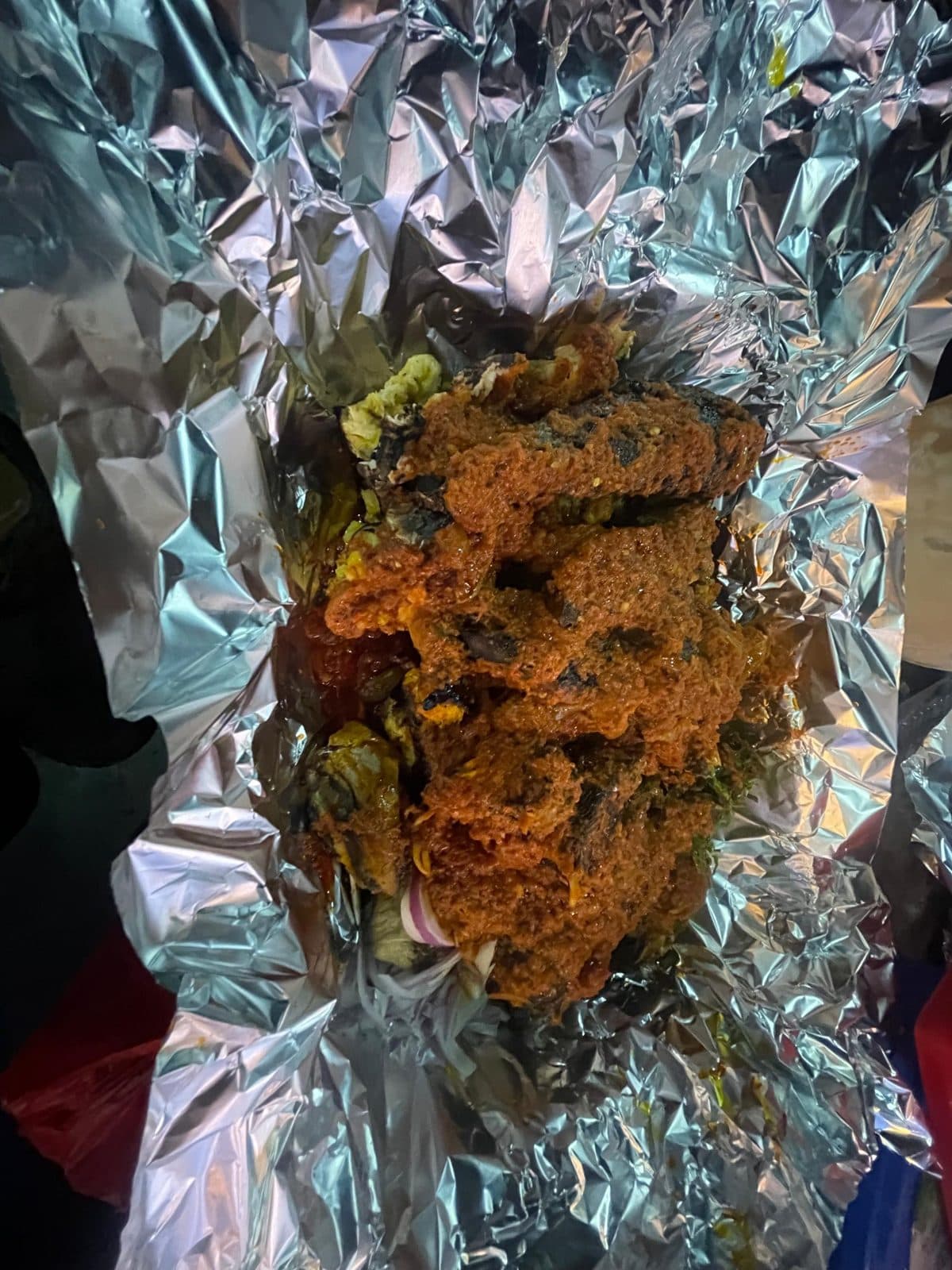 Grilled fish in pepper sauce wrapped in foil