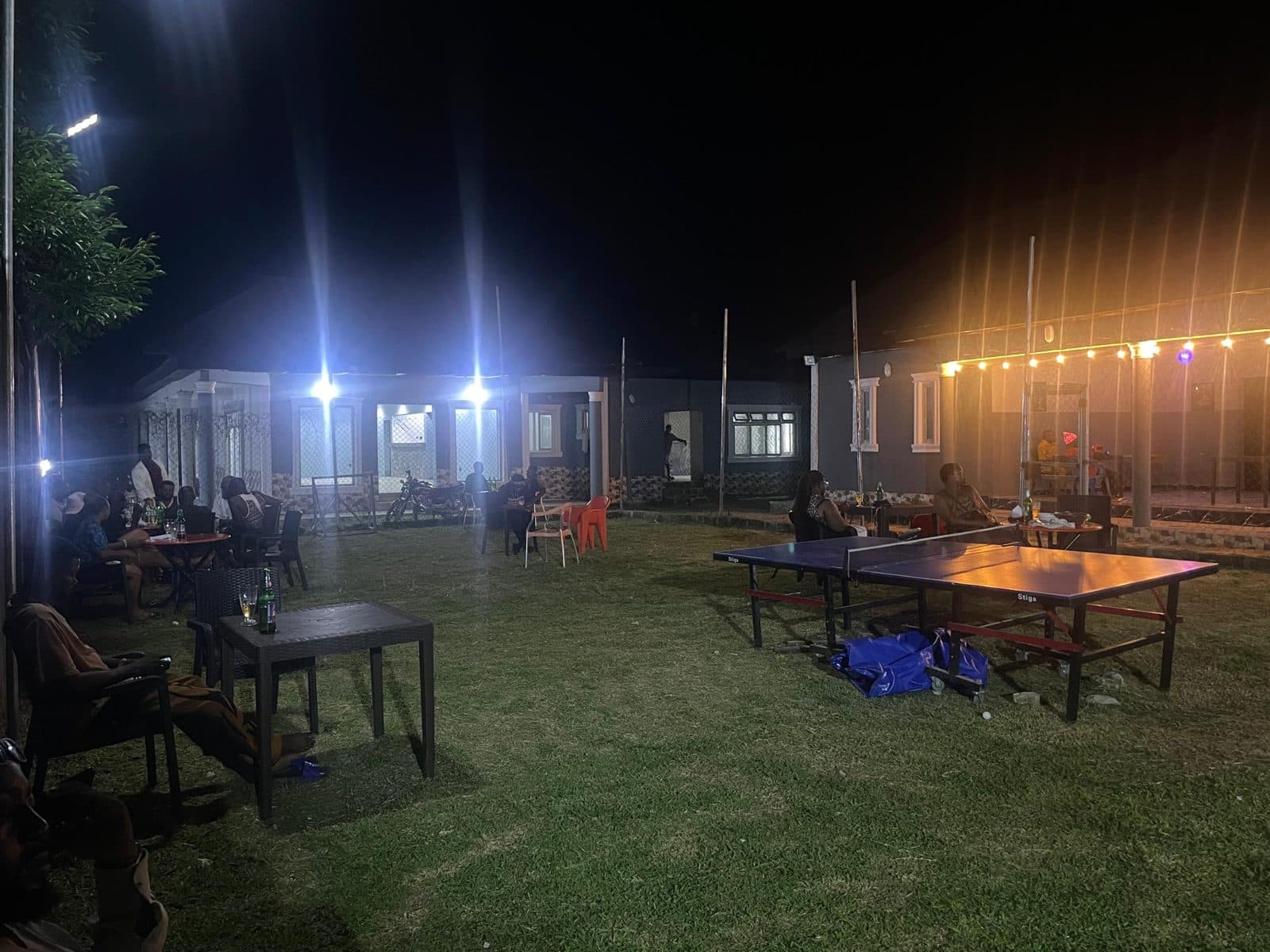 Table tennis and garden seating on the lawn at night