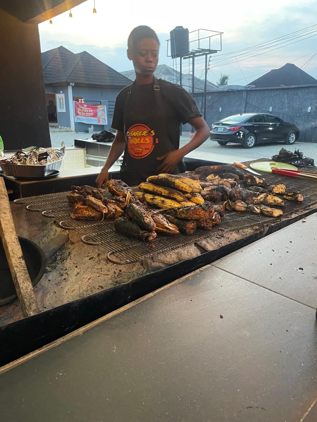 Plantain, yam and fish roasting on the charcoal grill